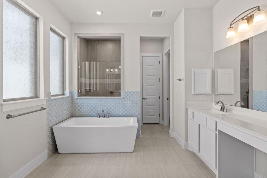 Primary Bath retreat with dual vanities, soaking tub & walk-in shower