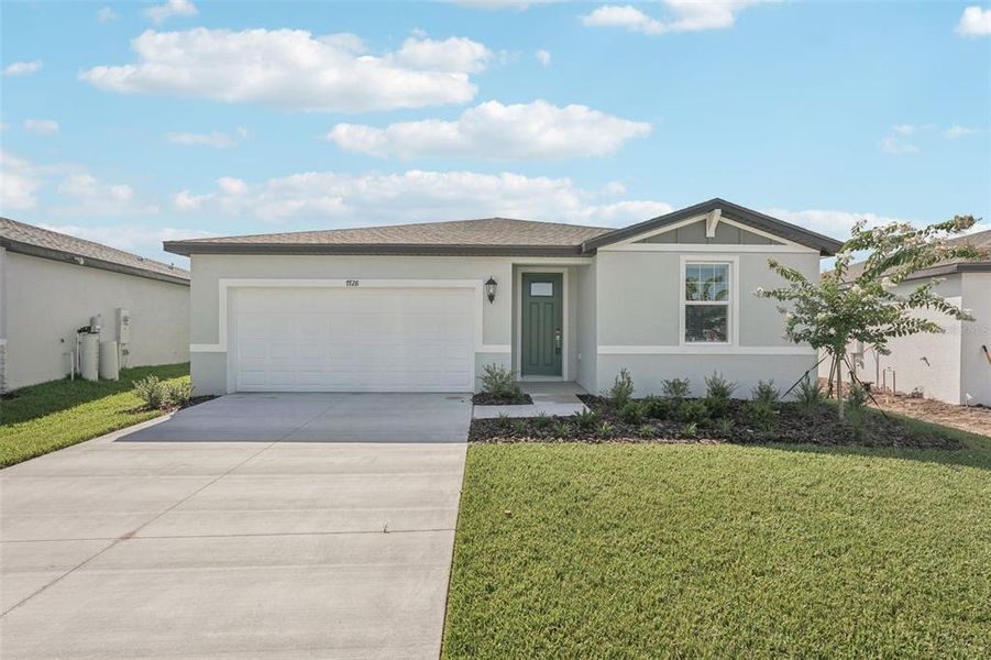 Front exterior of a new home in Salt Meadows - Classic Series, Parrish, FL, highlighting curb appeal (Image 2). Front exterior of a new home in Salt Meadows - Classic Series, Parrish, FL, highlighting curb appeal (Image 2).
