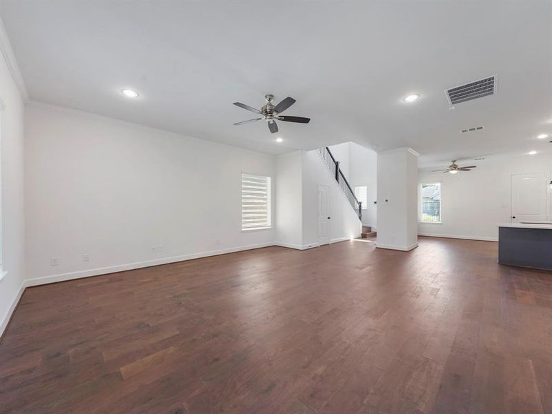 A large space for entertainment and relaxation, this Living Area boasts wood flooring and large windows, with an abundance of natural light. The space opens to the kitchen and dining area, creating the perfect open-concept layout. (Sample photos of a completed Warwick floor plan. The image may feature alternative selections and/or upgrades.)