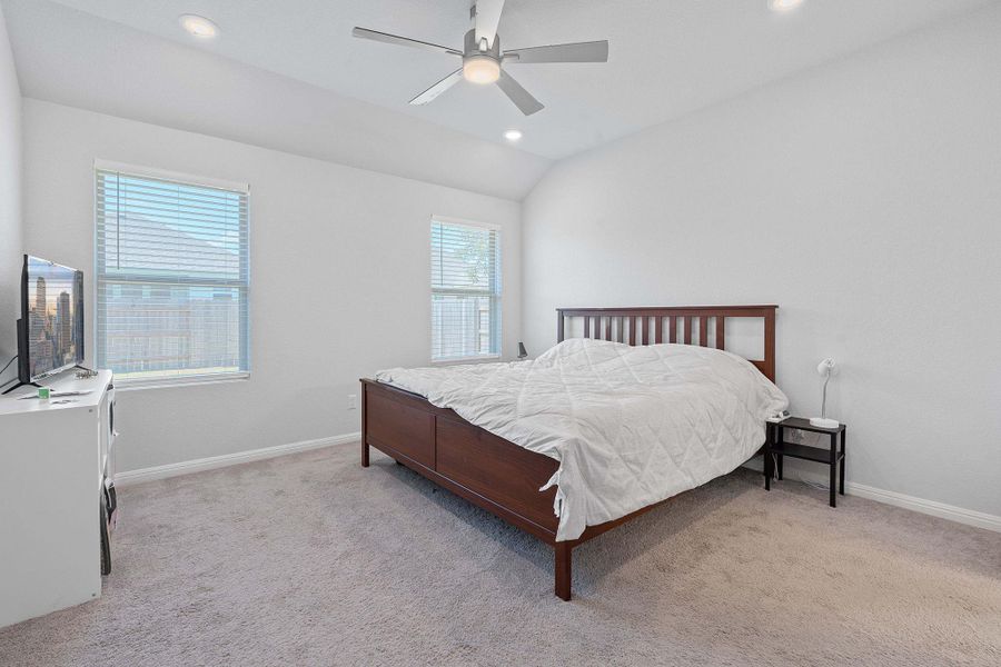 Bedroom with lofted ceiling, light colored carpet, recessed lighting, and a ceiling fan Bedroom with lofted ceiling, light colored carpet, recessed lighting, and a ceiling fan