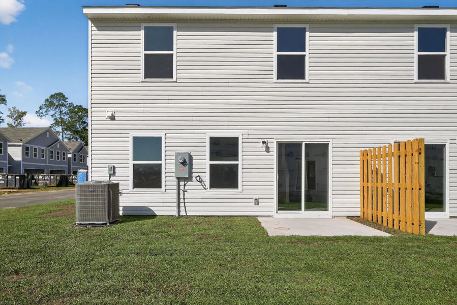 A white building with a yellow gate.