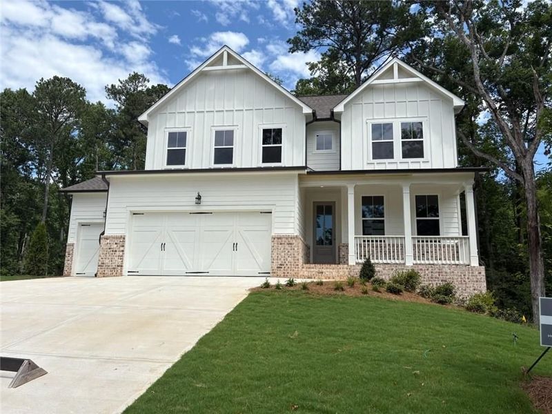 Front exterior of a new home in Riverwood, Dallas, GA, highlighting curb appeal (Image 124). Front exterior of a new home in Riverwood, Dallas, GA, highlighting curb appeal (Image 124).