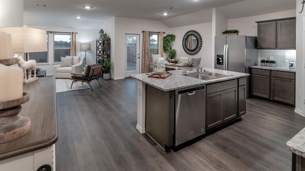Kitchen with stainless steel appliances, open floor plan, recessed lighting, an island with sink, and dark wood-type flooring
