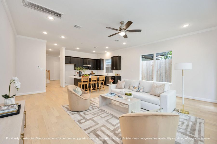 Recessed lighting and a stylish ceiling fan set the scene for tranquil evenings in the embrace of your expansive living room. Recessed lighting and a stylish ceiling fan set the scene for tranquil evenings in the embrace of your expansive living room.