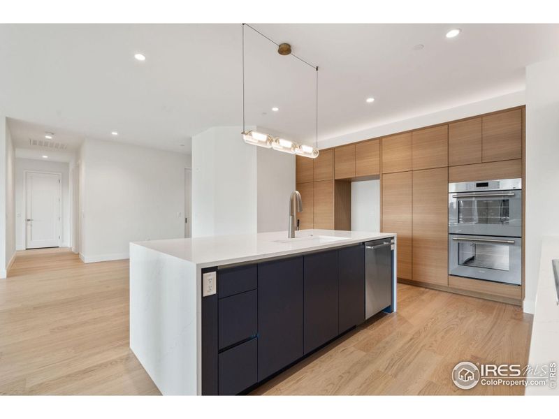 The waterfall edge on the quartz countertops compliments the custom European cabinetry and stainless Thermador appliances perfectly