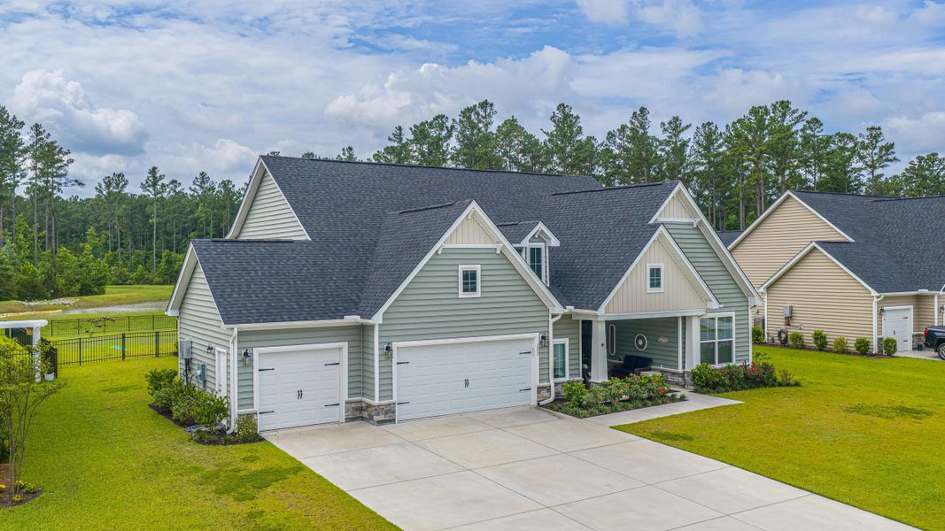 Front exterior of a new home in The Enclave at French Quarter Creek, Huger, SC, highlighting curb appeal (Image 27). Front exterior of a new home in The Enclave at French Quarter Creek, Huger, SC, highlighting curb appeal (Image 27).
