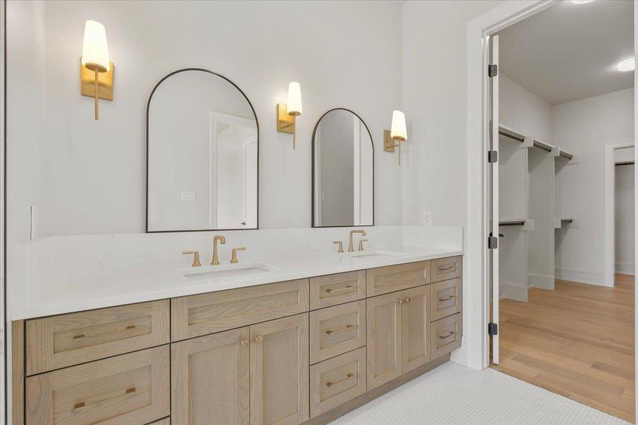 Double vanities with sleek fixtures and arched mirrors create a refined atmosphere. Double vanities with sleek fixtures and arched mirrors create a refined atmosphere.