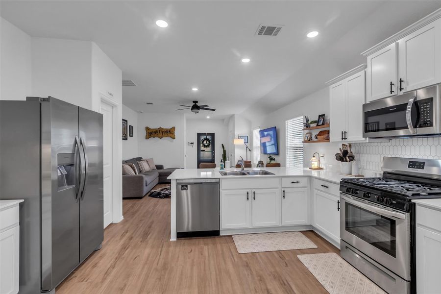 This kitchen has the perfect work triangle. The fridge, sink, and oven are conveniently located to one another. The vinyl floors are not only pretty but easy to maintain.