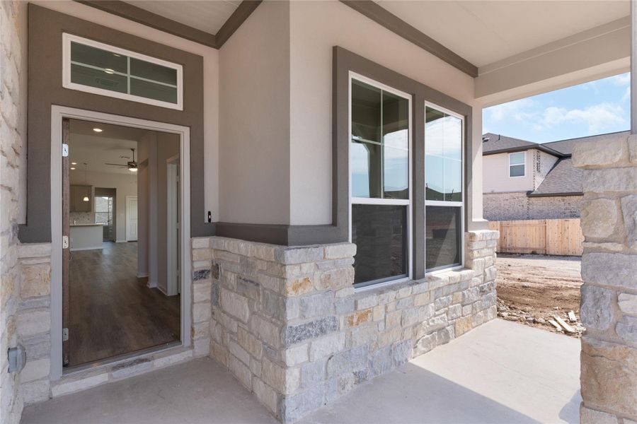 Property entrance featuring stone siding and stucco siding