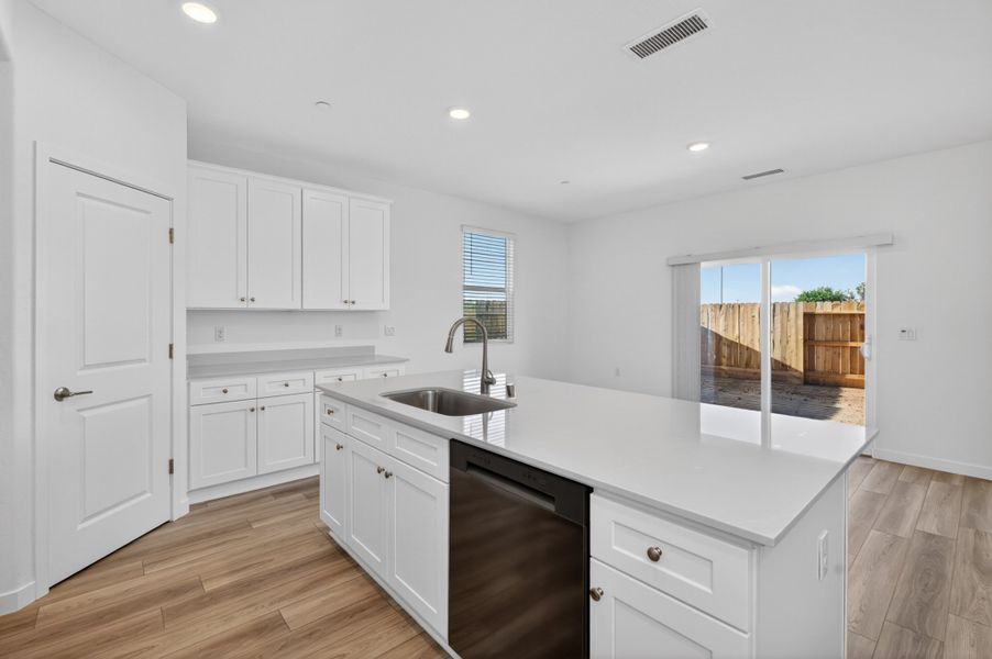 A kitchen with white cabinets. A kitchen with white cabinets.