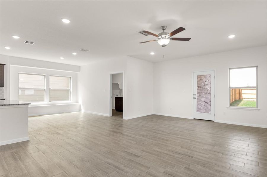 Unfurnished living room featuring visible vents, wood finished floors, recessed lighting, and a ceiling fan