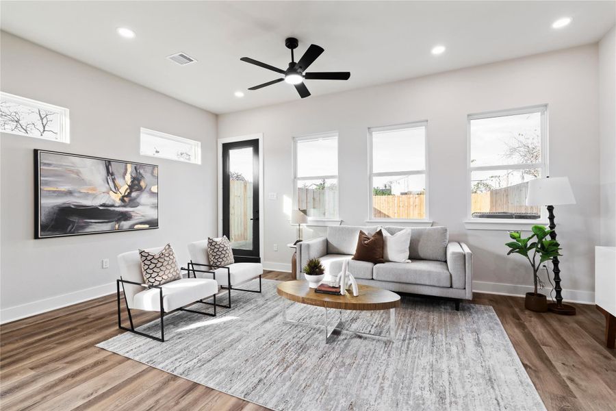 The living room feels bright and expansive, with high ceilings and an abundance of windows that fill the space with natural light. It’s a cozy yet open retreat that invites you to relax, recharge, and enjoy every moment at home.