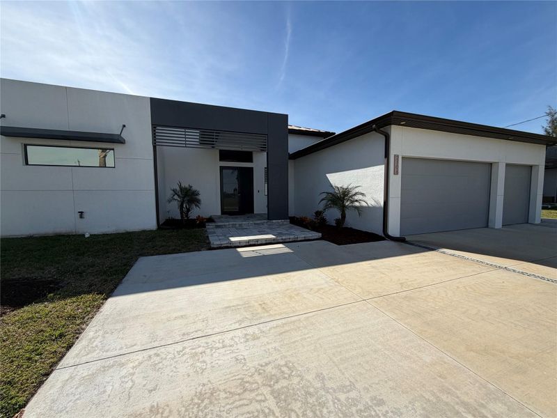 Front exterior of a new home in , Cape Coral, FL, highlighting curb appeal (Image 2).