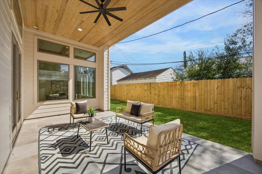 Enjoy the outdoors year-round on the covered patio, complete with a ceiling fan, recessed lighting, and a gas connection for grilling.