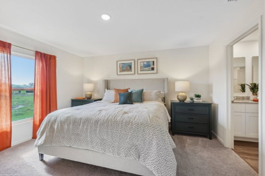 A bedroom with a large window. A bedroom with a large window.