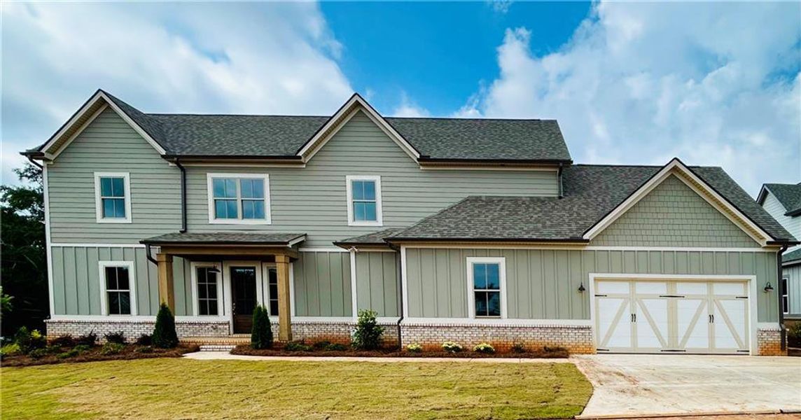 Front exterior of a new home in Trove, Watkinsville, GA, highlighting curb appeal (Image 1).