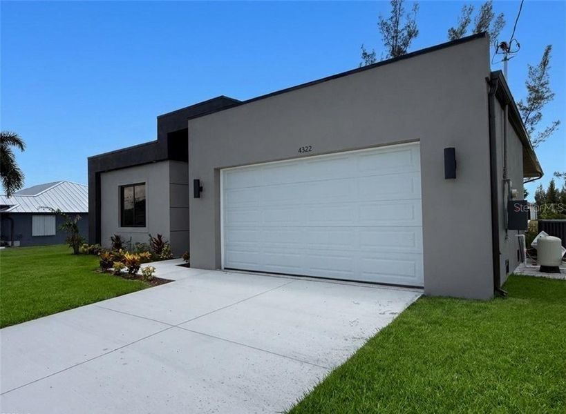 Front exterior of a new home in , Cape Coral, FL, highlighting curb appeal (Image 1). Front exterior of a new home in , Cape Coral, FL, highlighting curb appeal (Image 1).