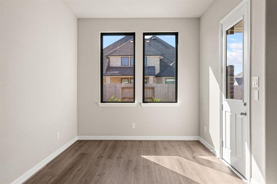 With an abundance of natural light streaming through the windows, the breakfast nook is bathed in a sunny glow, creating the perfect atmosphere to enjoy your morning coffee or a family breakfast.