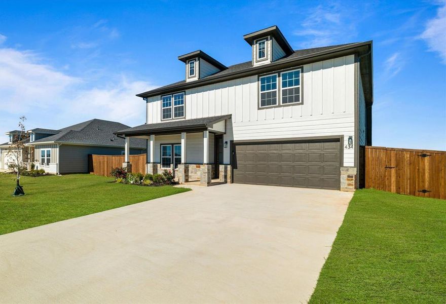 View of front of home featuring a garage and a front yard View of front of home featuring a garage and a front yard