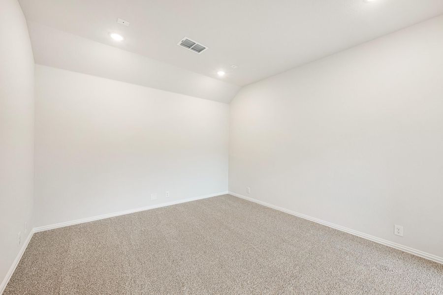 Empty room with white walls, beige carpet, and recessed ceiling lights