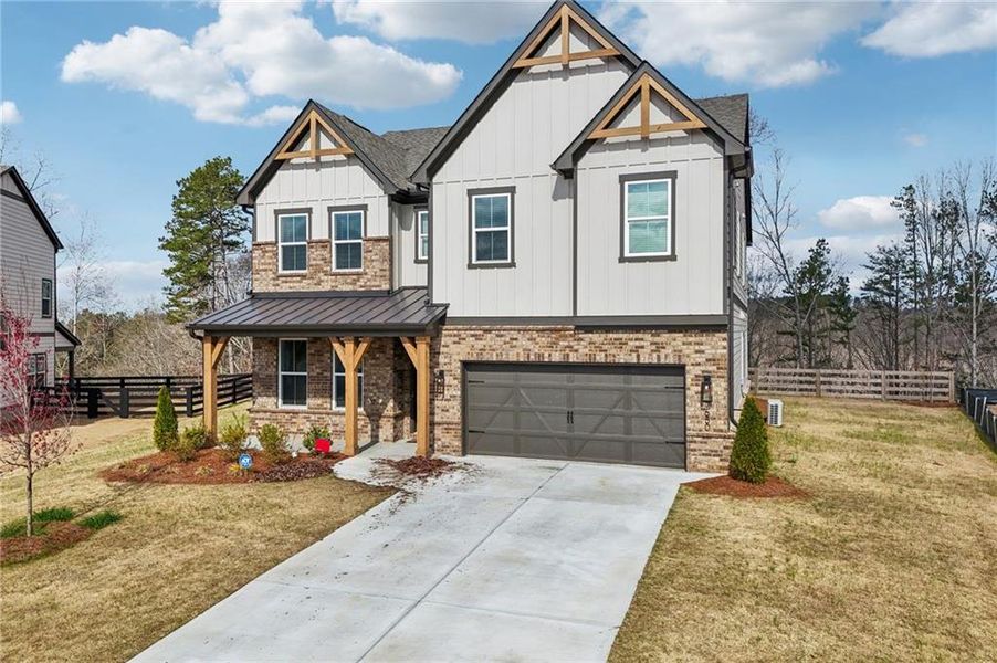 Front exterior of a new home in Tiberon Woods, Cumming, GA, highlighting curb appeal (Image 32). Front exterior of a new home in Tiberon Woods, Cumming, GA, highlighting curb appeal (Image 32).