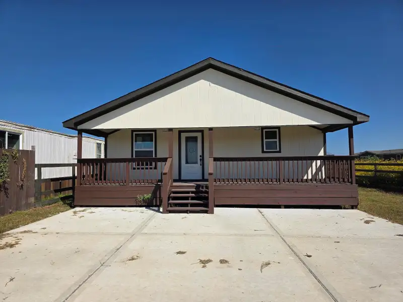 Front exterior of a new home in , Cleveland, TX, highlighting curb appeal (Image 1).
