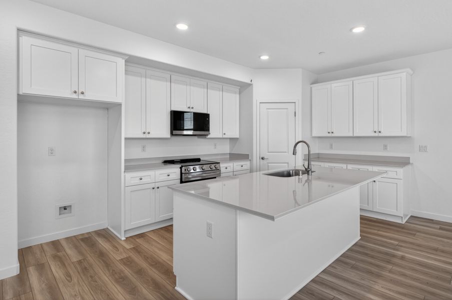 A kitchen with white cabinets. A kitchen with white cabinets.