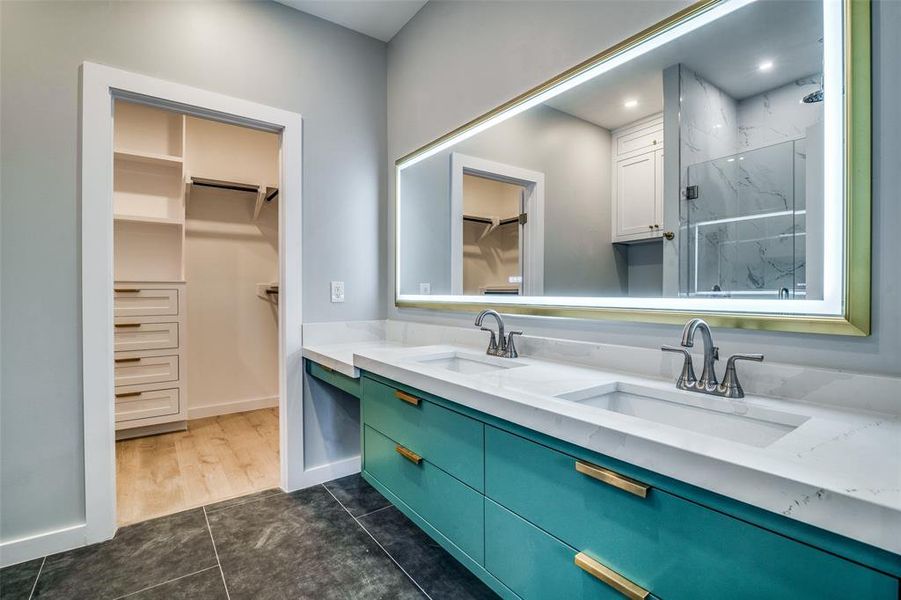 Bathroom with tile patterned flooring, vanity, and walk in shower