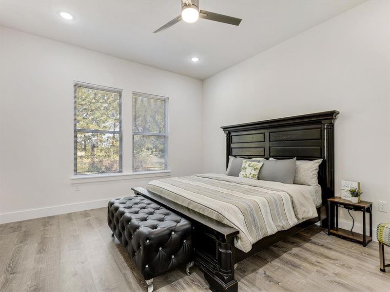 Bedroom with light wood-style flooring, recessed lighting, and a ceiling fan