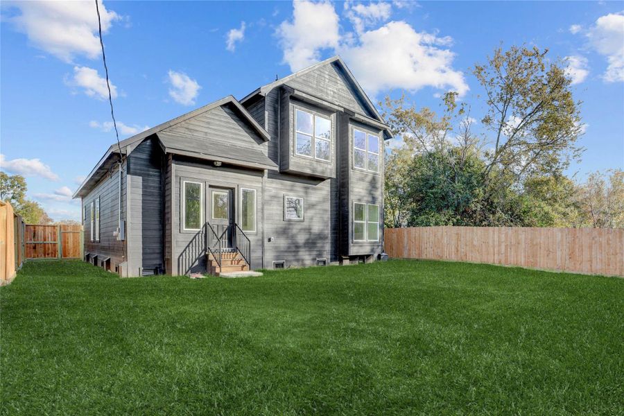 Spacious backyard is fully fenced (grass has been digitally added).
