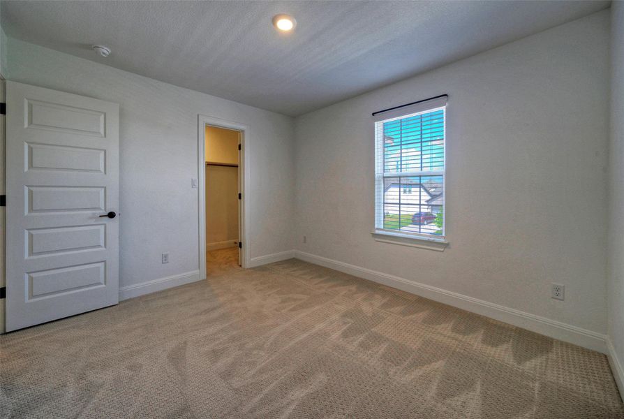 Soft carpeting pairs with neat trim and recessed lighting in this comfortable bedroom space. Soft carpeting pairs with neat trim and recessed lighting in this comfortable bedroom space.