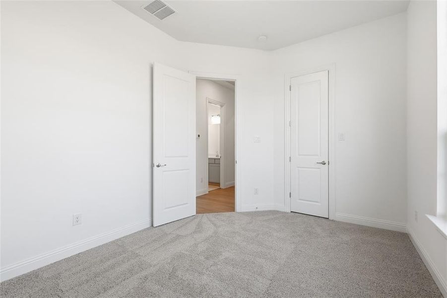 Unfurnished room with light carpet and baseboards
