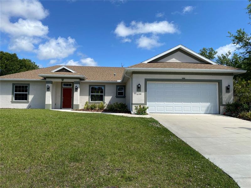 Front exterior of a new home in , North Port, FL, highlighting curb appeal (Image 1).