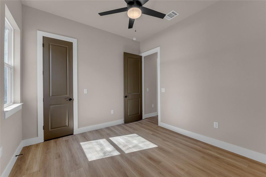 Unfurnished bedroom featuring light wood-type flooring and a ceiling fan