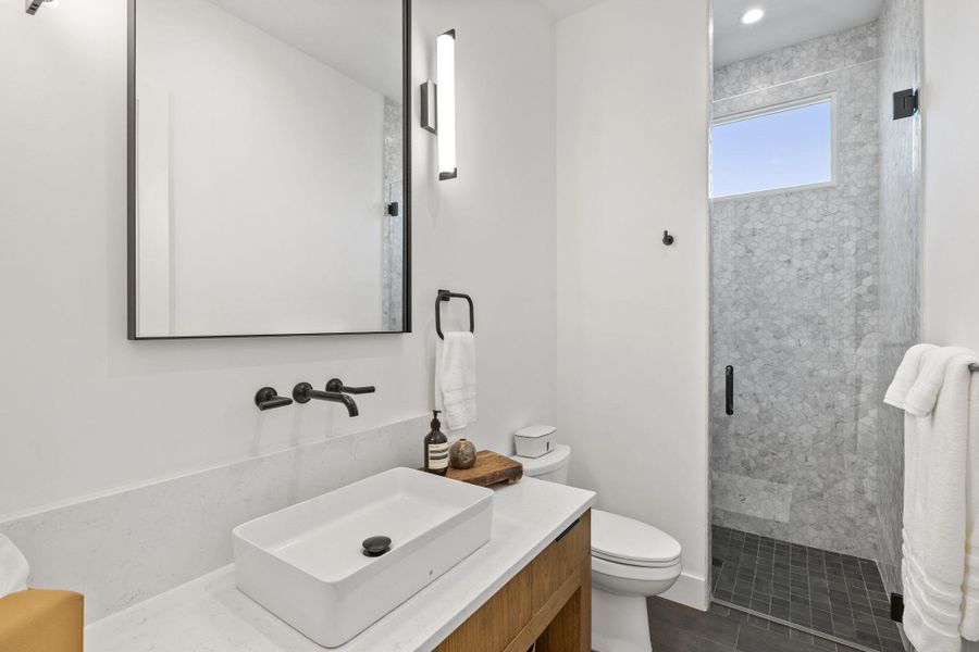 Bathroom featuring vanity and a stall shower