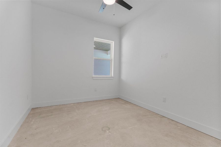 Unfurnished room with unfinished concrete floors and ceiling fan Unfurnished room with unfinished concrete floors and ceiling fan