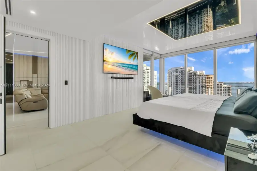 Floor-to-ceiling glass windows, high-gloss ceiling paneling, white vertical slat wall detailing, and light-toned large-format tile flooring Floor-to-ceiling glass windows, high-gloss ceiling paneling, white vertical slat wall detailing, and light-toned large-format tile flooring