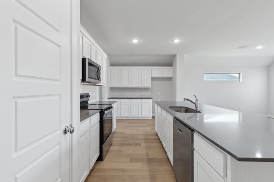 Kitchen in the Harrison home plan by Trophy Signature Homes – REPRESENTATIVE PHOTO