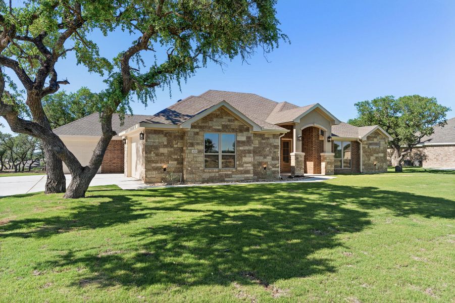 View of front of house featuring a front lawn, brick siding, roof with shingles, and an attached garage View of front of house featuring a front lawn, brick siding, roof with shingles, and an attached garage