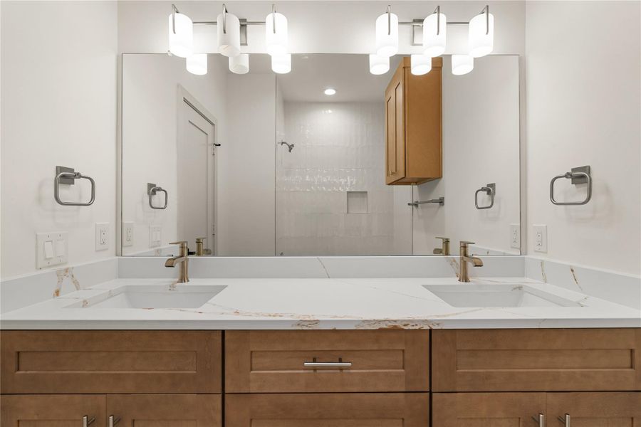 Secondary bath — double vanity with quartz countertop and walk-in shower Secondary bath — double vanity with quartz countertop and walk-in shower