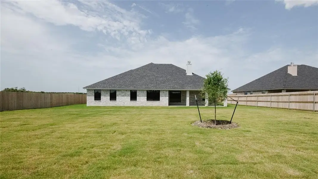 Rear view of property with brick siding and a shingled roof Rear view of property with brick siding and a shingled roof