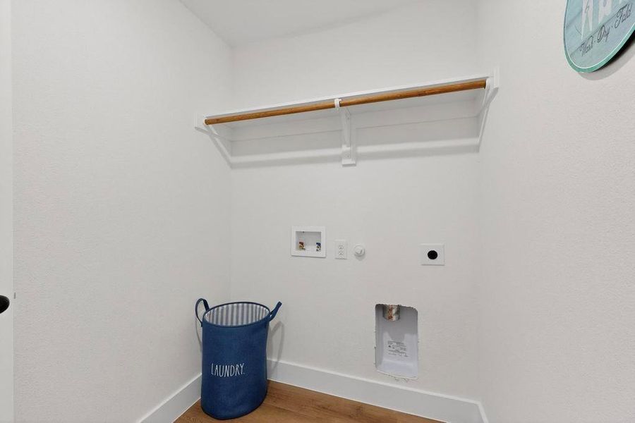 Laundry area with hookup for a gas dryer, wood finished floors, electric dryer hookup, and hookup for a washing machine Laundry area with hookup for a gas dryer, wood finished floors, electric dryer hookup, and hookup for a washing machine