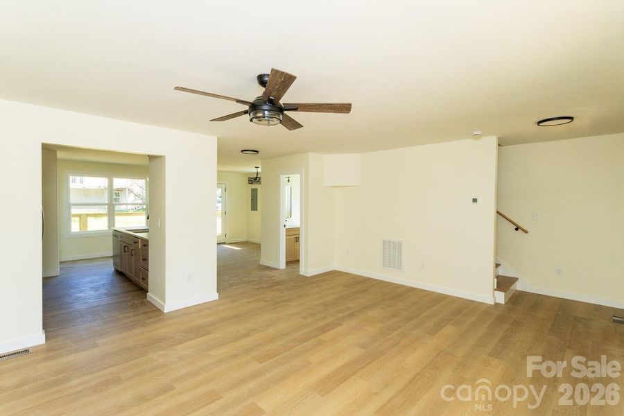 Looking in from corner of living room toward dining room and 1/2 bath