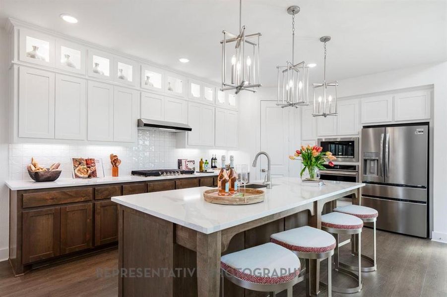 Kitchen featuring white cabinets, stainless steel appliances, dark wood-style floors, decorative backsplash, and recessed lighting