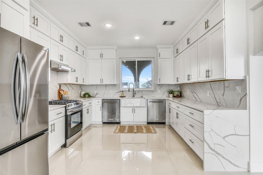 This kitchen was designed to keep the party moving. Quartz surfaces, stainless appliances, generous prep space and soft-close cabinetry provide polished style with the performance serious cooks appreciate. This kitchen was designed to keep the party moving. Quartz surfaces, stainless appliances, generous prep space and soft-close cabinetry provide polished style with the performance serious cooks appreciate.