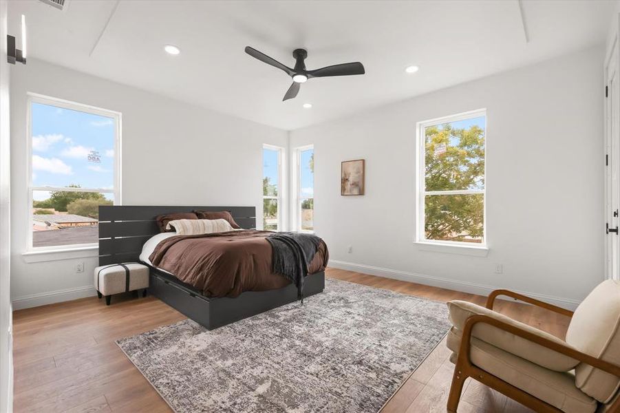Bedroom featuring light wood-type flooring, recessed lighting, and ceiling fan Bedroom featuring light wood-type flooring, recessed lighting, and ceiling fan