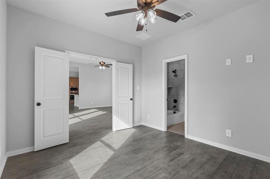 Unfurnished room with ceiling fan and hardwood / wood-style flooring