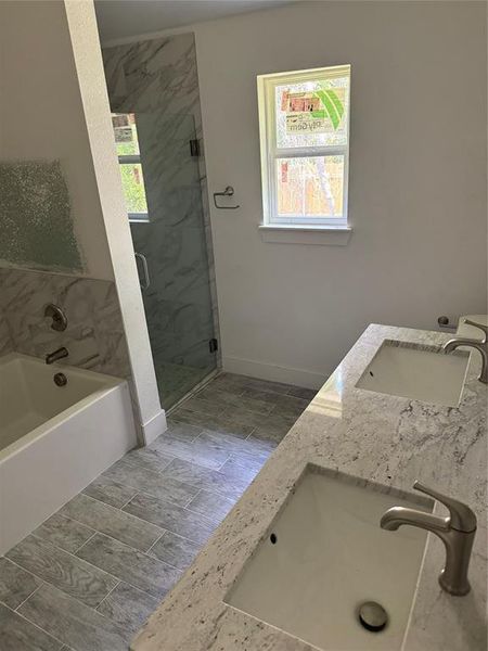 Another view of the Master Bathroom with shower with separate bathtub, tile patterned floors, and double vanity