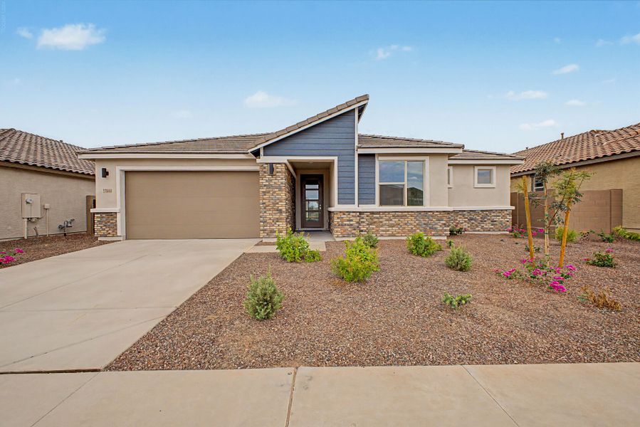 Front exterior of a new home in Tierra Vistoso, Surprise, AZ, highlighting curb appeal (Image 1). Front exterior of a new home in Tierra Vistoso, Surprise, AZ, highlighting curb appeal (Image 1).