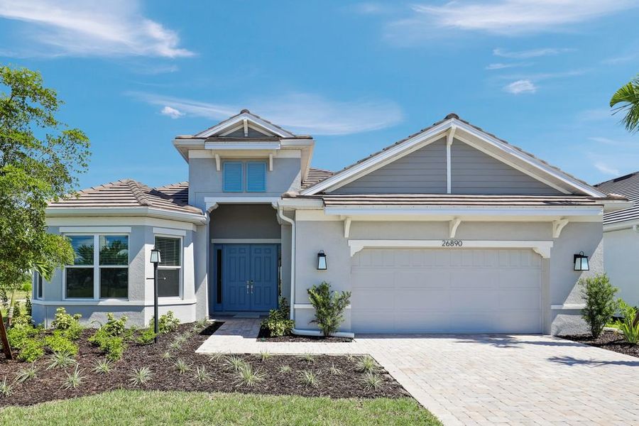 Front exterior of a new home in Esplanade at Starling, Punta Gorda, FL, highlighting curb appeal (Image 1). Front exterior of a new home in Esplanade at Starling, Punta Gorda, FL, highlighting curb appeal (Image 1).